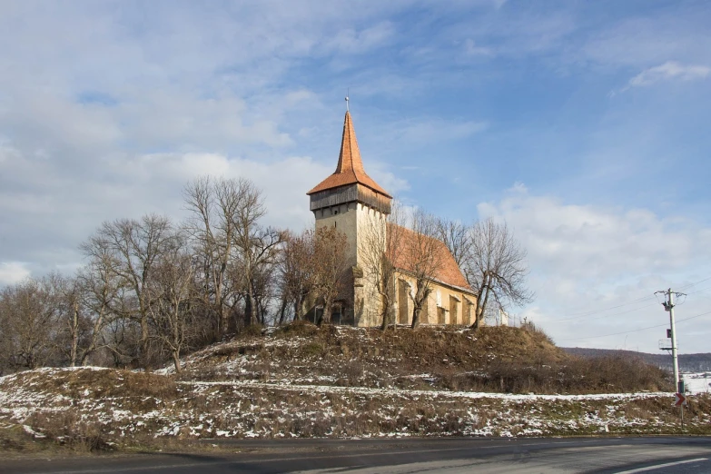 a church sitting on top of a hill next to a road, by Thomas Häfner, romanesque, andrzej marszalek, 4 5. 7 mplens, january, cone