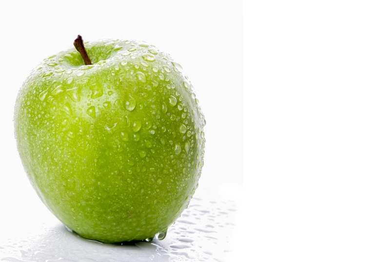 a green apple with water droplets on it, istockphoto, the background is white, panzer, banner