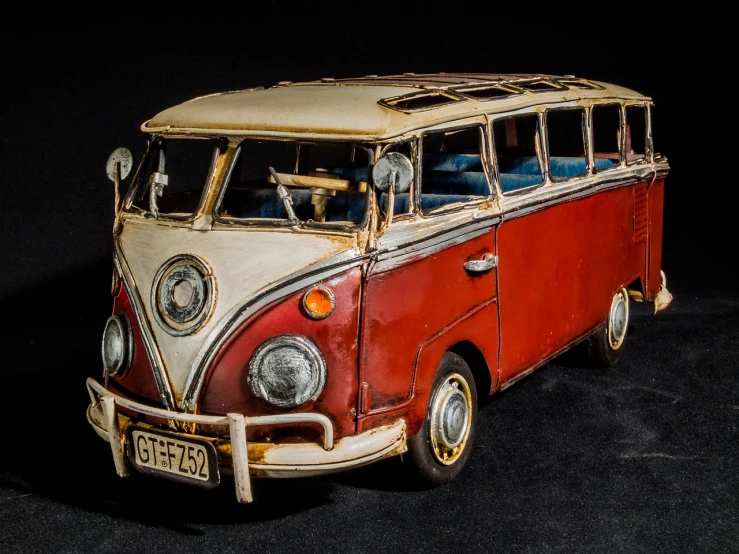 a red and white bus sitting on top of a black surface, by Richard Carline, stained antique copper car paint, wolfgang lettl highly detailed, rusted junk, kombi