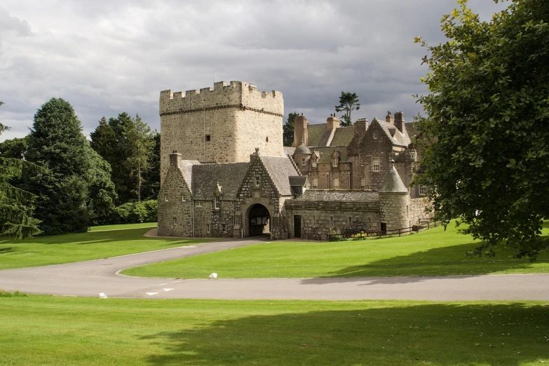 a large castle sitting on top of a lush green field, inspired by Dugald Sutherland MacColl, inside a castle courtyard, in scotland, exterior view, museum quality photo