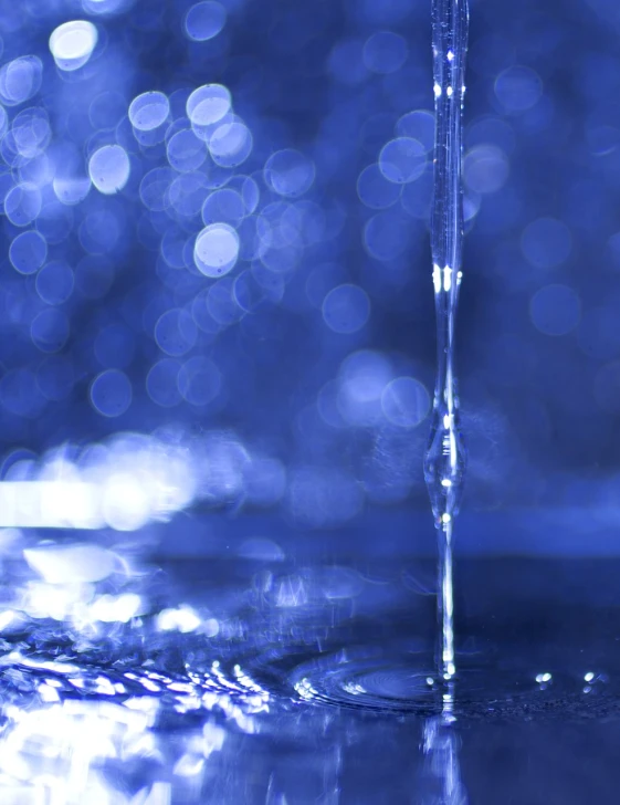 a close up of water dripping from a faucet, a digital rendering, by Edward Corbett, flickr, minimalism, intricate sparkling atmosphere, blue reflections, banner, bokeh photo