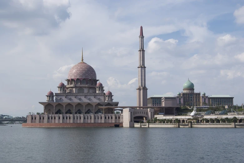 a large building sitting on top of a body of water, by Basuki Abdullah, shutterstock, hurufiyya, spires, sparsely populated, pillar, malaysian