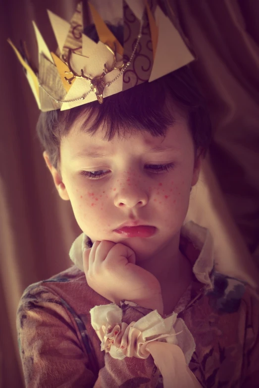 a young boy with a crown on his head, a picture, by Edward Corbett, pexels, looking tired, pimples, retro effect, the little prince