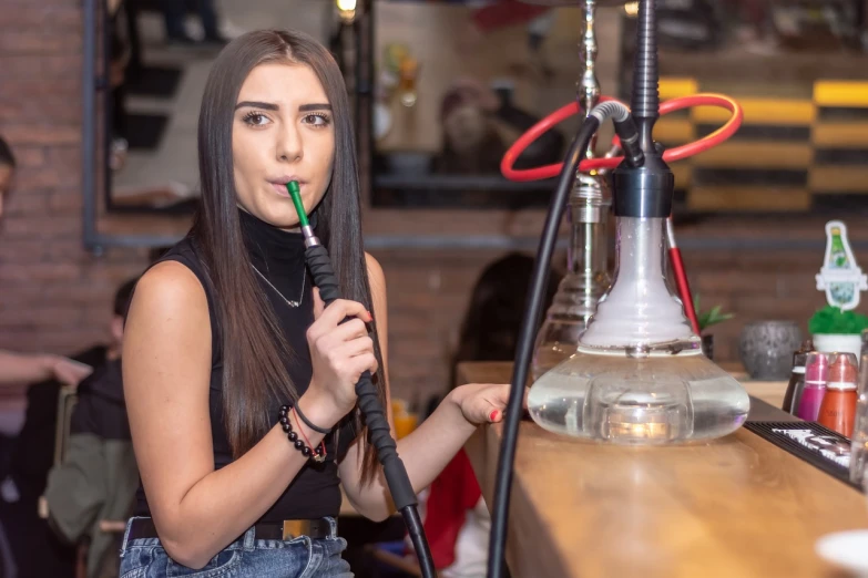 a woman sitting at a table with a hook in her mouth, by Adam Marczyński, shutterstock, hurufiyya, a hookah smoking caterpillar, people drink cocktails, good young girl, in the pub