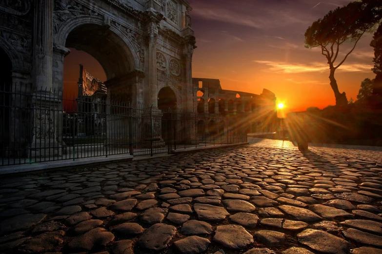 the sun is setting over a cobblestone street, by Antonio Rotta, pexels contest winner, romanticism, in a coliseum, gate, caesar, perfect shot