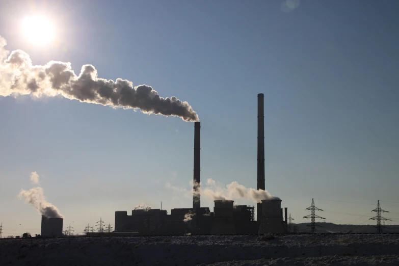 a factory with a lot of smoke coming out of it, a picture, shutterstock, purism, winter sun, stock footage