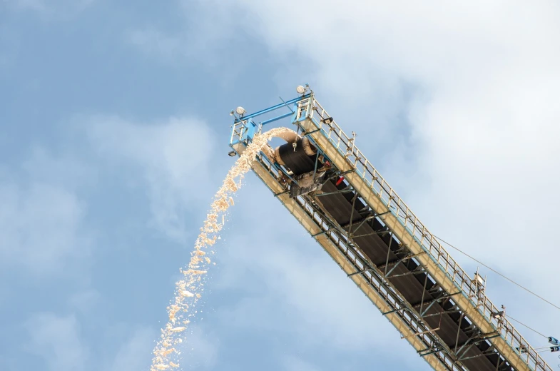 a crane is pouring grain into the sky, view from bottom to top, high res photo, lots of fire, snacks