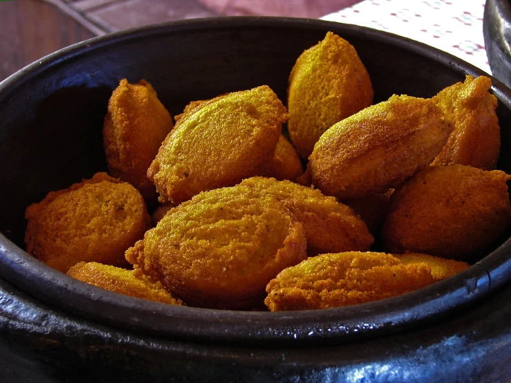 a close up of a bowl of food on a table, flickr, hurufiyya, deep fried, pumpkins, colombian, favolaschia - calocera