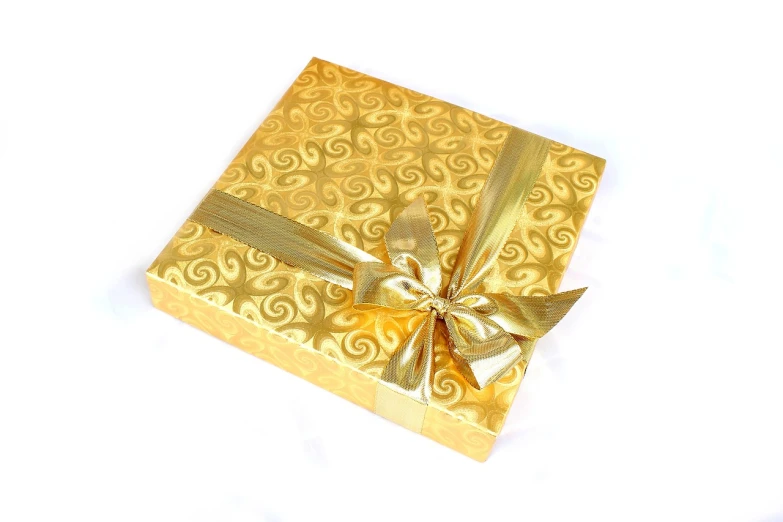 a gold gift box with a bow on a white background, kodak photo, thai, chocolate, modern very sharp photo