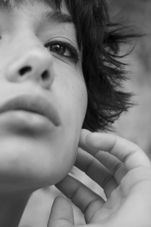 a close up of a person holding a cell phone to their ear, a black and white photo, by Etienne Delessert, realism, lovely delicate face, neck zoomed in from lips down, portrait androgynous girl, soft portrait shot 8 k