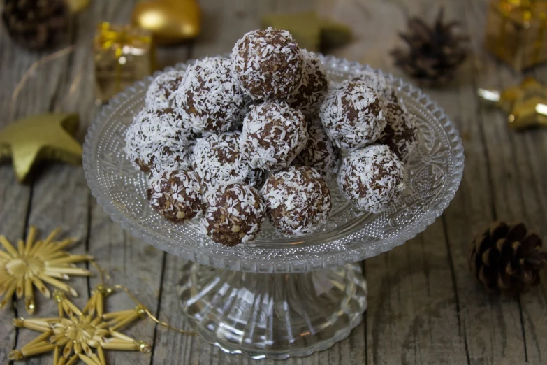 a glass bowl filled with donuts covered in powdered sugar, inspired by Balázs Diószegi, hurufiyya, rocky roads, balls of rice, high quality product image”