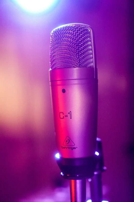 a close up of a microphone on a stand, by Matt Cavotta, purple color lighting, vibrant - c 10, with beautiful volumetric light, dorian cleavanger