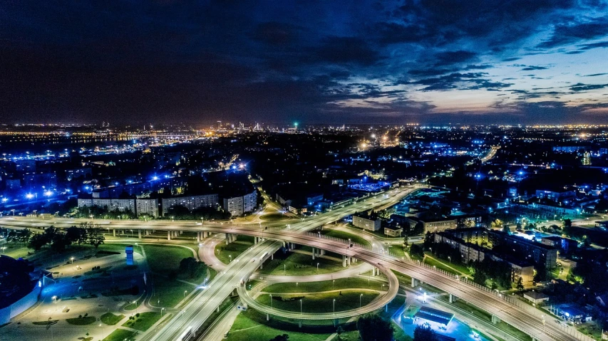 an aerial view of a city at night, a stock photo, by Adam Marczyński, pexels contest winner, happening, ultrawide shots, traffic with light trails, dutch masterpiece, over the horizon