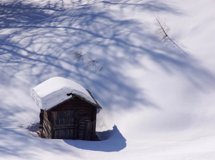 a small shed sitting in the middle of a snow covered field, by Matthias Weischer, flickr, romanticism, deep shadows and colors, in the dolomites, great light and shadows”, konica minolta