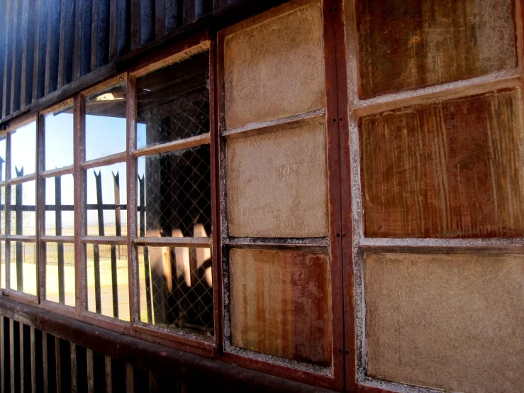 a close up of a window on a building, by Peter Churcher, flickr, rural wastelands, train, sliding glass windows, light inside the hut