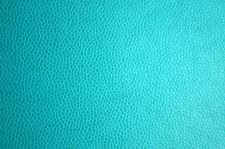 a close up of a blue leather surface, a stipple, inspired by Yahoo Kusama, trending on pixabay, color field, cyan dimensional light, shiny textured plastic shell, grain kodak, eggshell color