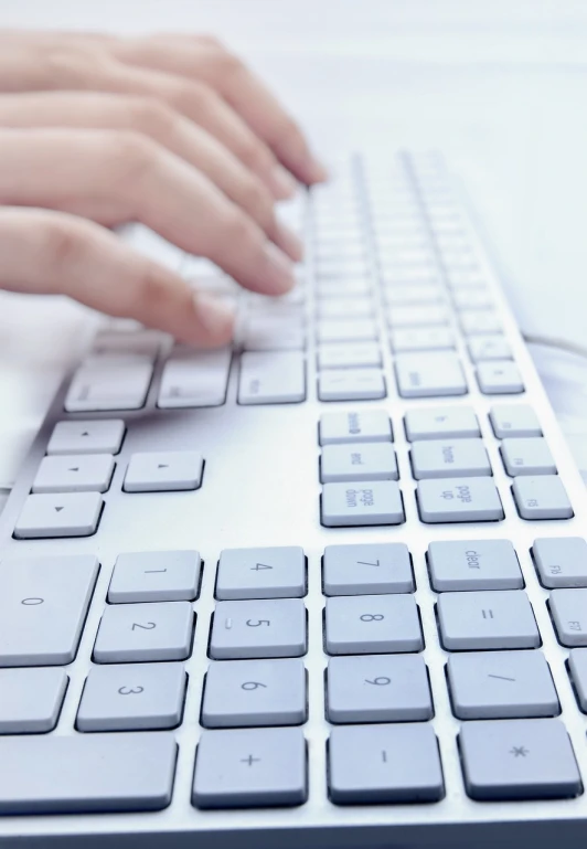 a close up of a person typing on a keyboard, a digital rendering, by Julian Allen, shutterstock, white hue, sales, wide screenshot, highkey