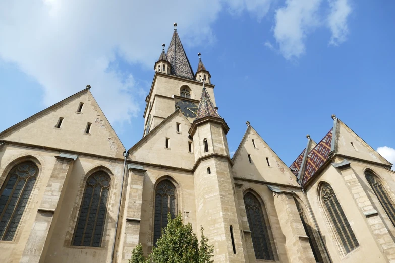 a very tall building with a clock on it's side, by Thomas Häfner, romanesque, churches, view from bottom, auslese, bells