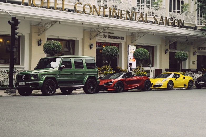 a row of cars parked in front of a hotel, pexels contest winner, maximalism, richard mille, hoang long ly, convertible, trio