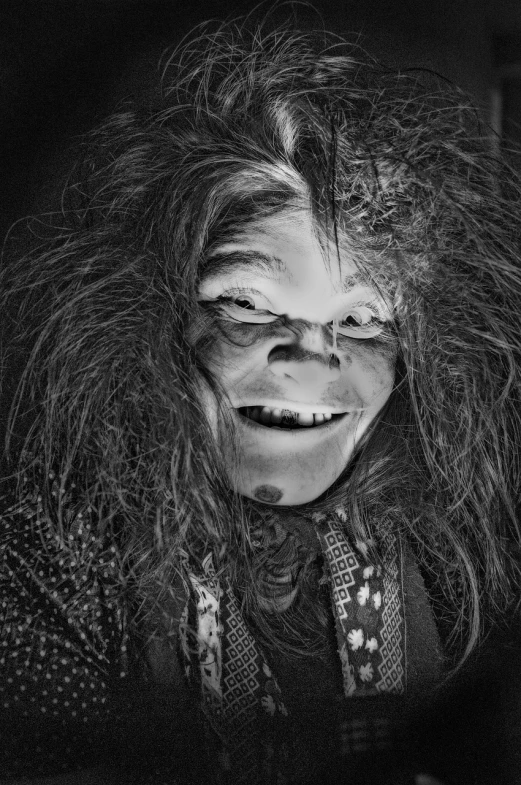 a close up of a person with long hair, a black and white photo, inspired by Judith Leyster, featured on cgsociety, an orc smiling into the camera, the grinch, dramatic smile pose intricate, in costume