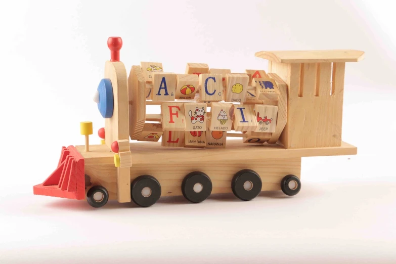 a wooden toy train sitting on top of a table, by Helen Berman, detailed letters, activity play centre, skin, side front view
