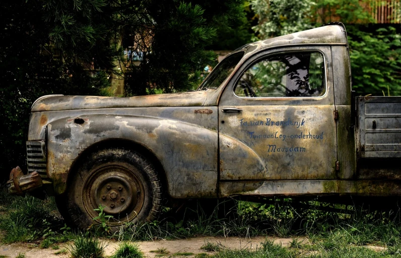 an old truck that is sitting in the grass, a portrait, inspired by Fabien Charuau, unsplash, photorealism, covered in dirt, portrait!!!, renault, 1942