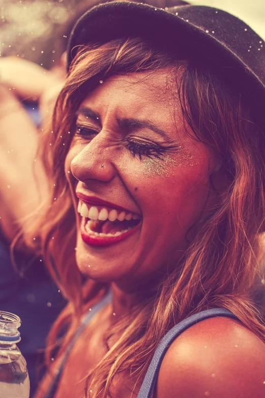 a close up of a person wearing a hat, pexels contest winner, happening, laughter and screaming face, tomorrowland, grungy woman, glitter gif