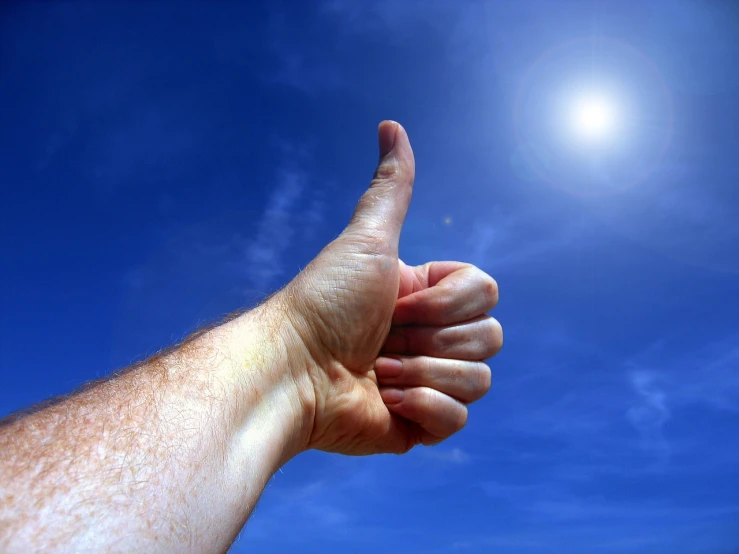 a person giving a thumbs up with the sun in the background, by Jan Rustem, figuration libre, accurate detail, pure blue sky, high details photo, very accurate photo