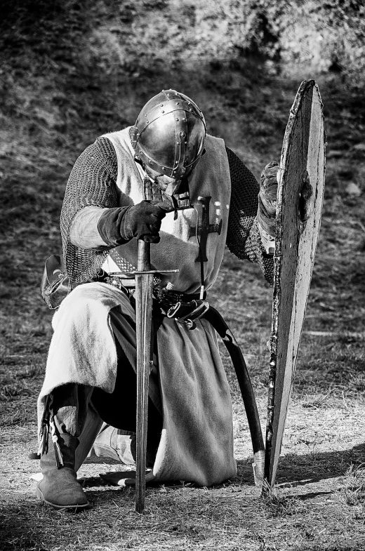 a black and white photo of a man in armor, inspired by Howard Pyle, flickr, blocking the sun, round about to start, captured on canon eos r 6, viking style