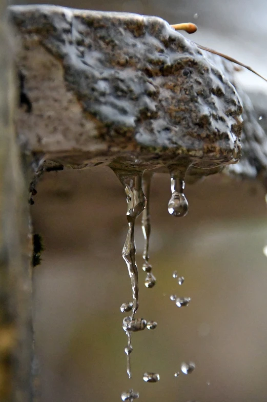 a close up of water dripping from a faucet, by Jan Rustem, wet rocks, icicles, dripping wax, accurate and detailed