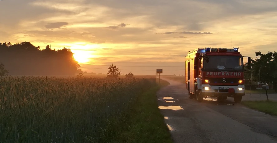 a fire truck driving down a rural road, a picture, by Robert Zünd, pexels, happening, summer morning, liquid fire, widescreen, wallpaper - 1 0 2 4