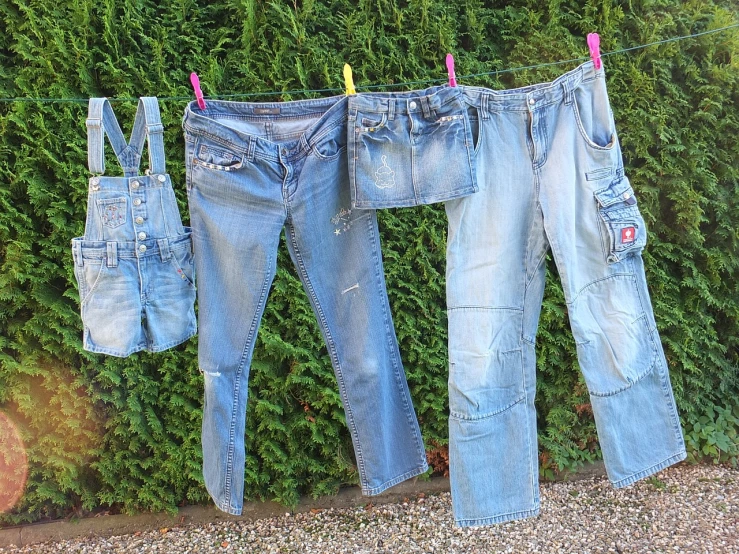 two pairs of jeans hanging on a clothes line, by Christen Dalsgaard, dada, wearing dirty overalls, 3 - piece, normal clothes, clothes!