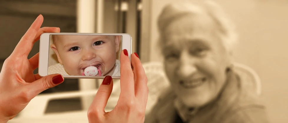 a woman taking a picture of a baby with a cell phone, a picture, pixabay, photorealism, an old lady with red skin, old sepia photography, snapchat photo, face in-frame