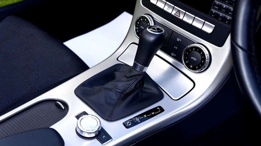 a close up of a gear stick in a car, les automatistes, slr, black leather accents, 872637744, charcoal and silver color scheme