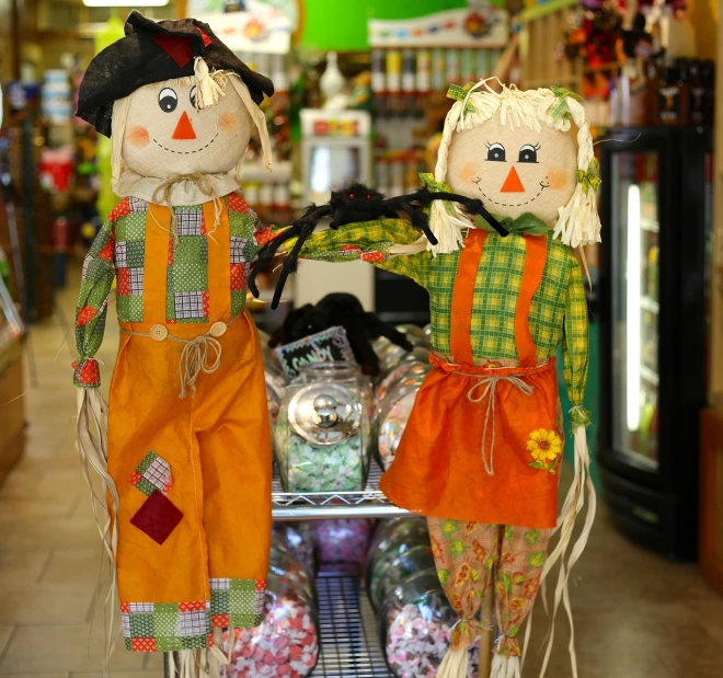 a couple of scarecrows sitting on top of a shopping cart, a portrait, folk art, candy shop in a mall, photo”, high res photo