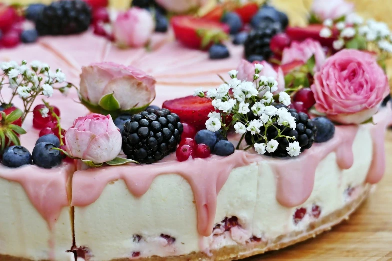 a cake sitting on top of a wooden table, a pastel, inspired by Dóra Keresztes, pexels, romanticism, made of flowers and berries, 😃😀😄☺🙃😉😗, pink power, alternate angle