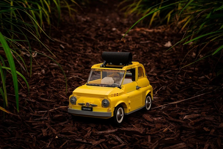 a toy car with a suitcase on top of it, inspired by Leo Leuppi, unsplash, photorealism, deep in a japanese bamboo forest, minifigure, fully detailed render, (((yellow)))