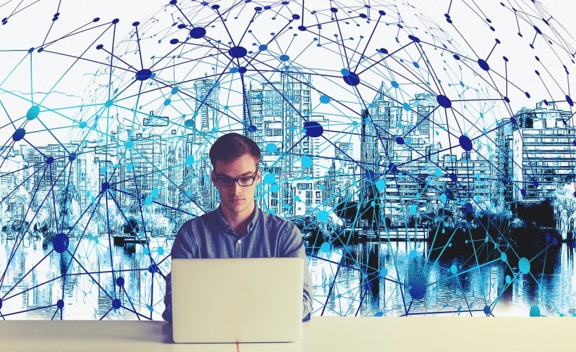 a man sitting in front of a laptop computer, digital art, shutterstock, immersed within a network, analysis city, stock photo, istockphoto