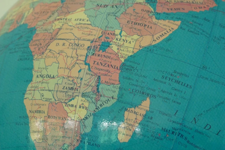 a close up of a globe on a table, by Daniel Lieske, excessivism, unmistakably kenyan, mappa, 1960s-era, wip