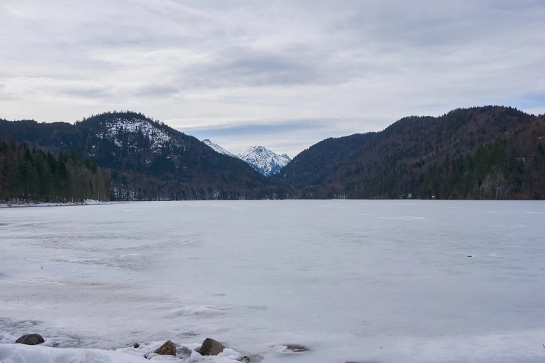 a view of a frozen lake with mountains in the background, les nabis, black forest, tochigi prefecture, whistler, far away from camera