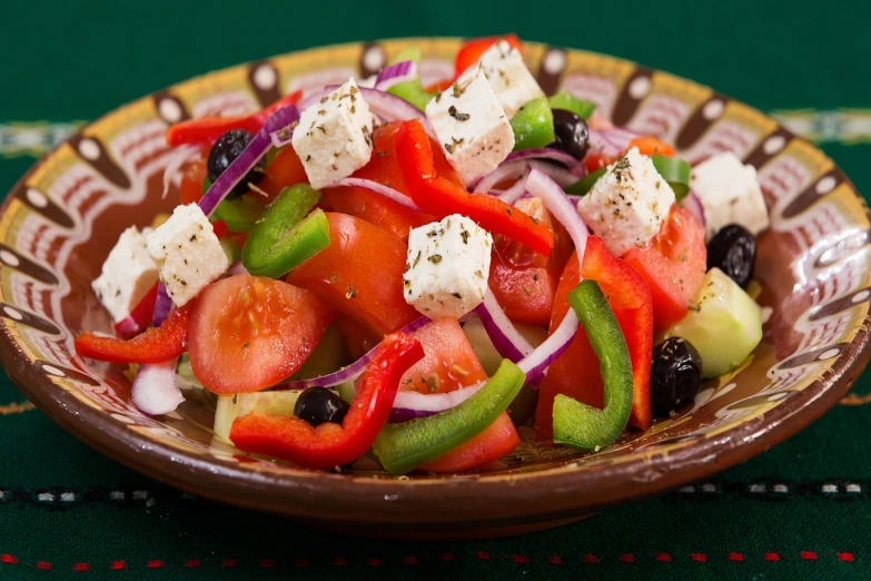 a close up of a plate of food on a table, shutterstock, dau-al-set, salad, greek style, pepper, full of colors