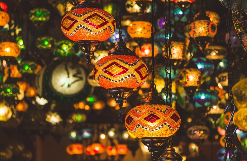 a bunch of colorful lights hanging from a ceiling, a mosaic, by Micha Klein, pexels, middle eastern style vendors, orange light, 🦩🪐🐞👩🏻🦳, avatar image