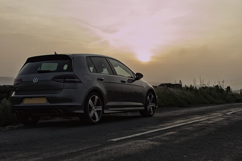 a car is parked on the side of the road, a picture, by Adam Marczyński, pexels contest winner, romanticism, wrx golf, gun metal grey, late afternoon sun, banner