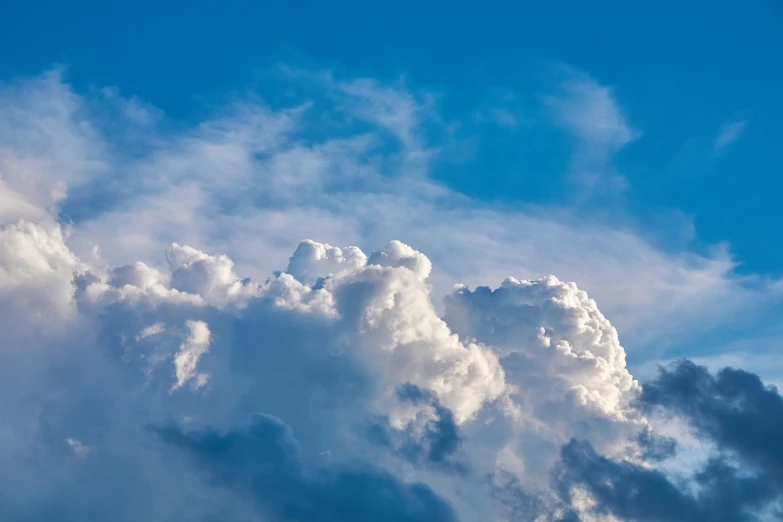 a jetliner flying through a cloudy blue sky, a picture, by Jan Rustem, towering cumulonimbus clouds, 4k vertical wallpaper, a close up shot, dominant wihte and blue colours