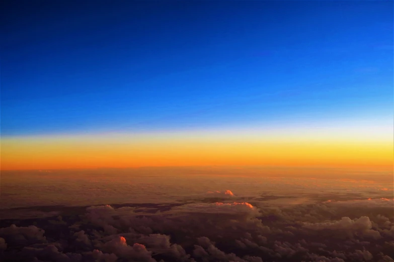 a view of the sky and clouds from an airplane, by Jan Rustem, flickr, sunrise colors, blue and yellow gradient, sky night, tropical atmosphere