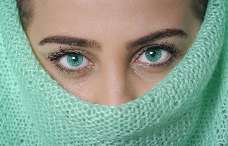 a close up of a person with green eyes, shutterstock, hurufiyya, scarf, aqua glass eyes, eyes). full body, gorgeous woman