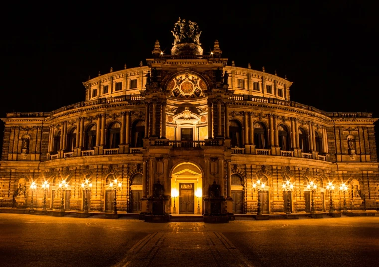 a large building that is lit up at night, by Juergen von Huendeberg, shutterstock, baroque, arena, germany. wide shot, savannah, ultrawide lens”