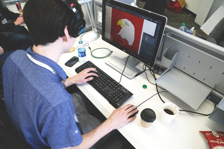 a man sitting at a desk in front of a computer, a digital rendering, inspired by NEVERCREW, pexels, patriotism, phoenix-inspired, professional product photography, tyler