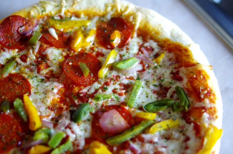 a pizza sitting on top of a white plate, by Sam Dillemans, hurufiyya, colourful close up shot, spicy, veggies, sun is shining