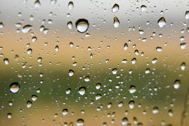 a close up of water droplets on a window, high res photo, hiperdetailed